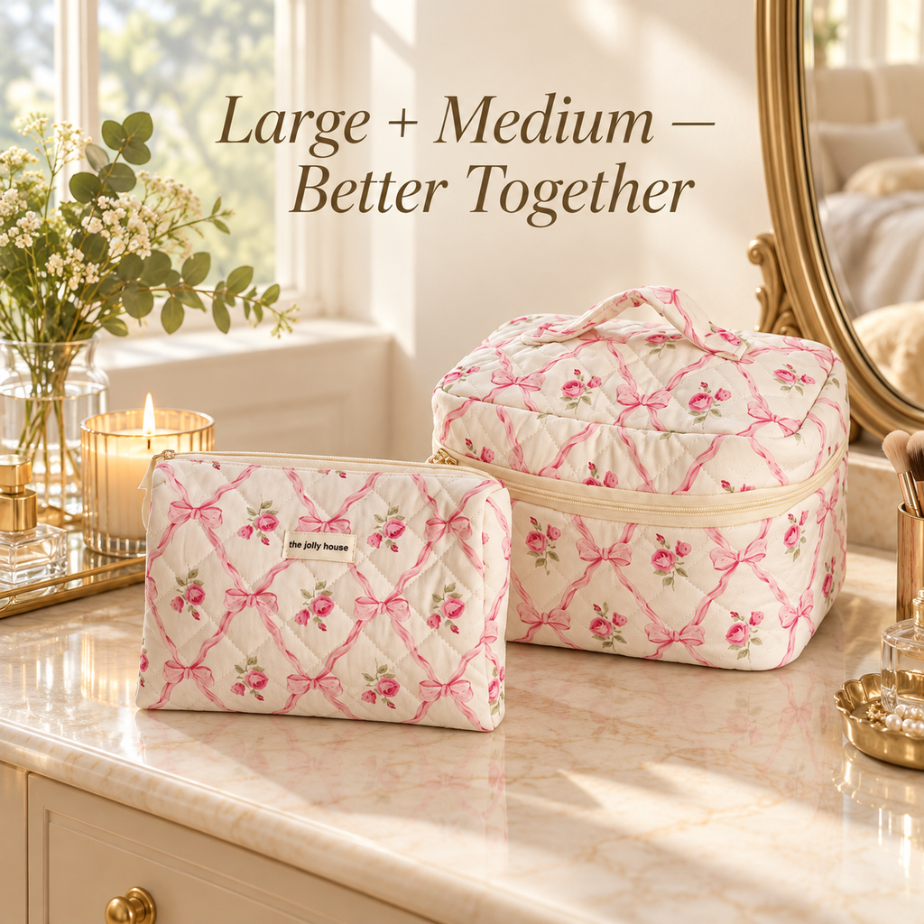 Pink bow and rose quilted makeup bags in Large and Medium on a marble vanity with a gold mirror and flowers