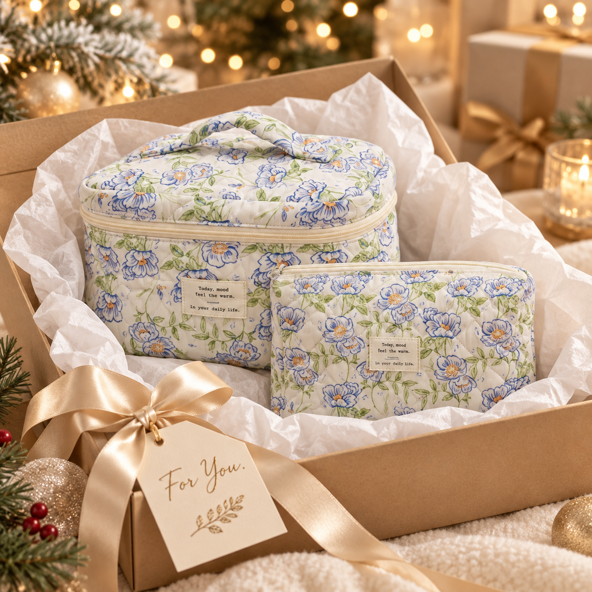 Blue floral quilted makeup bags in Large and Medium in a gift box with tissue paper and gold ribbon