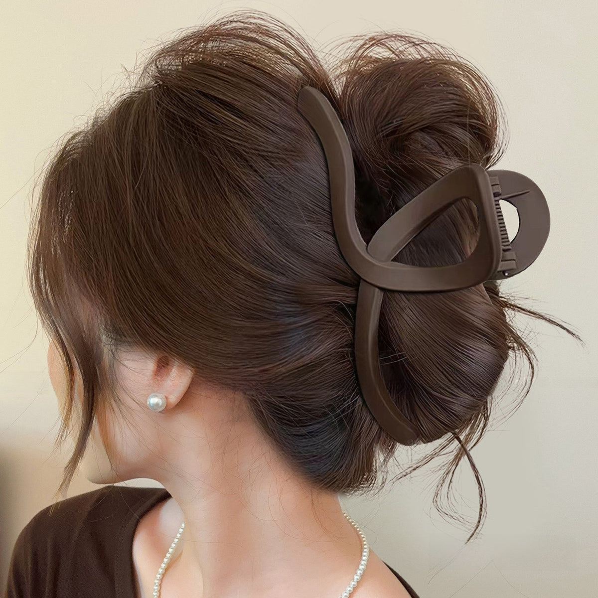 Matte dark coffee brown classic claw clip in an updo
