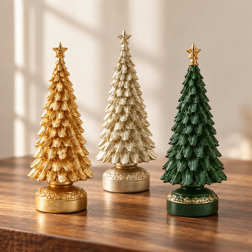 Set of 3 resin tabletop Christmas trees in gold, light gold and green on a wooden table
