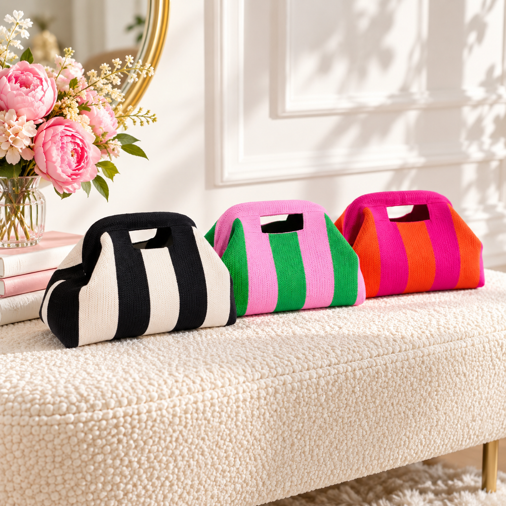 Striped knit cloud handbags in black & cream, pink & green and pink & orange on a cream boucle bench with pink peonies