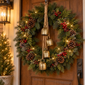 Rustic gold Christmas bell hanger with jute rope hanging from a pine wreath on a wooden front door
