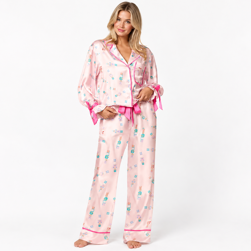 Pink nutcracker satin pajama set with pink satin tie waist and bow cuffs, front view