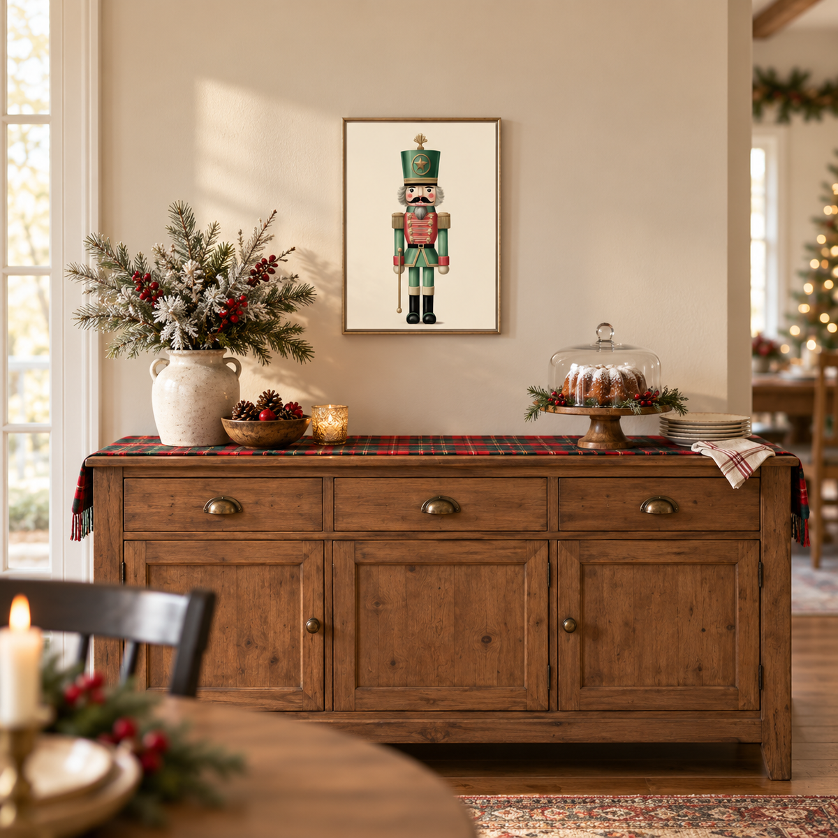 Evergreen nutcracker framed print above a wooden sideboard with holiday decor