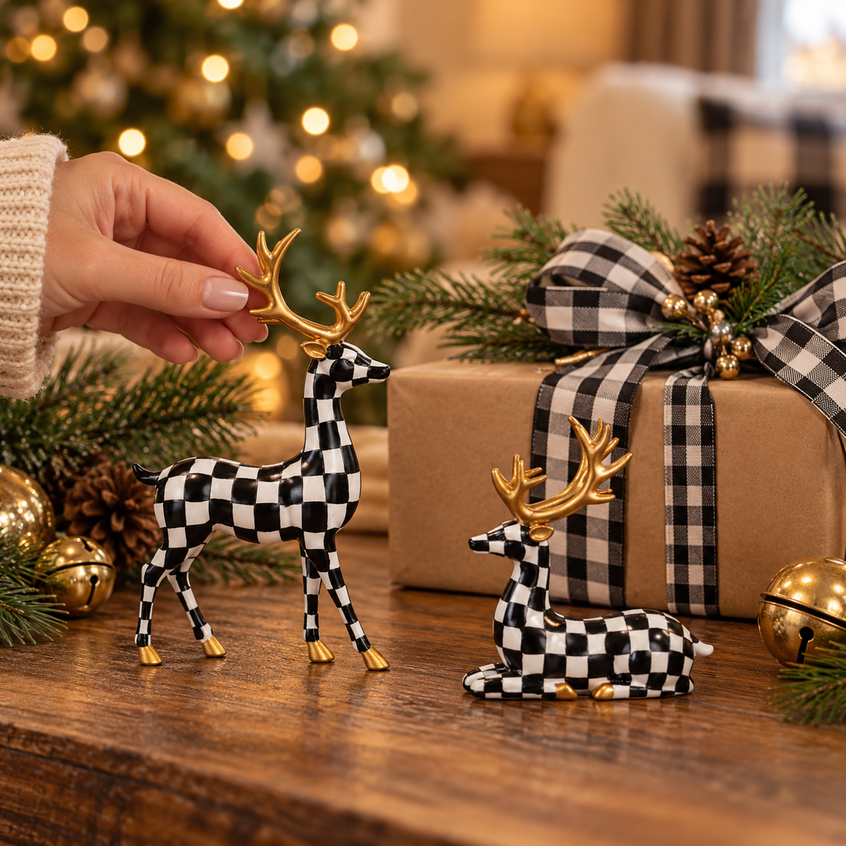 Hand touching a small checkered Christmas deer figurine beside a wrapped gift to show its size
