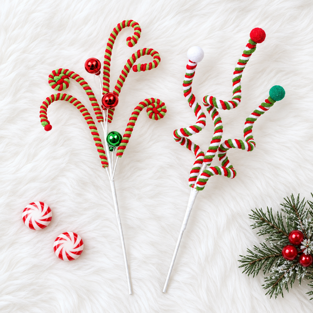 Curly candy cane spray and twisted pom-pom spray Christmas picks side by side on white faux fur