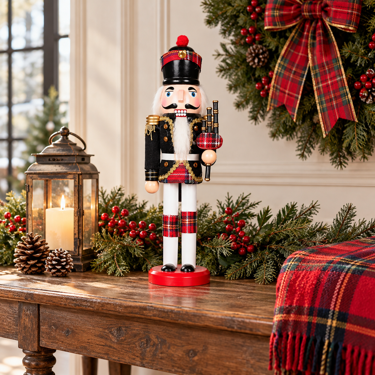 Tartan bagpiper nutcracker on a rustic wood entryway table with a lantern, evergreen garland, red tartan throw and a wreath with a plaid bow